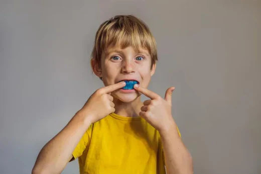 A child wearing a mouth guard