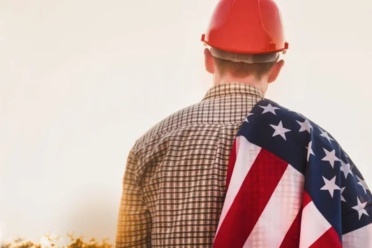 A man celebrating Labor Day holding the US flag