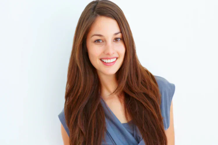 A young girl smiling to show her straight teeth