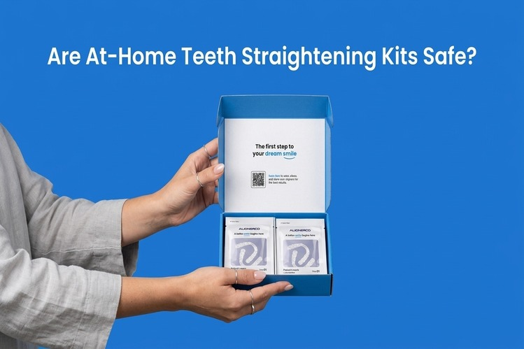 Hands holding an open at-home teeth straightening kit box