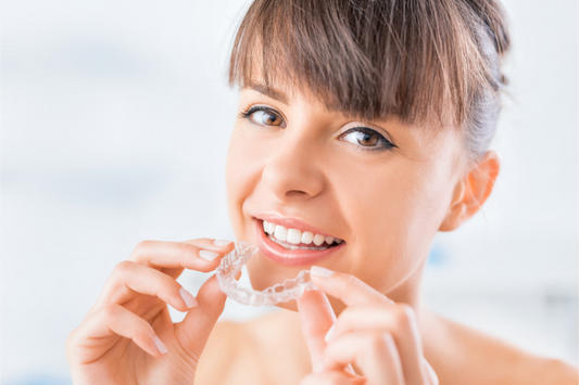 Woman Holding an Invisible Aligners 