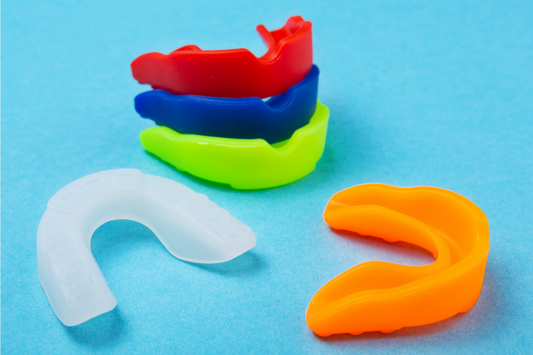 An image shows several colors of boxing mouth guards