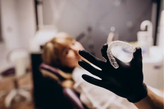 A person holding a clear aligner