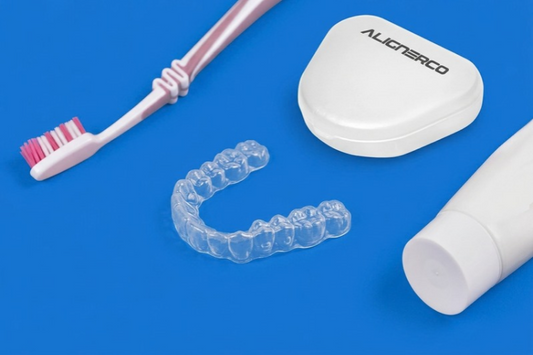 ALIGNERCO aligners, case, toothbrush and toothpaste on a blue background