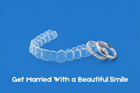Clear aligner and wedding rings on blue background