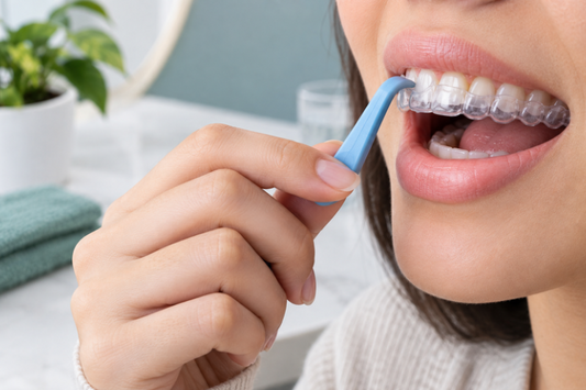 Woman using a blue removal tool to take out a clear aligner