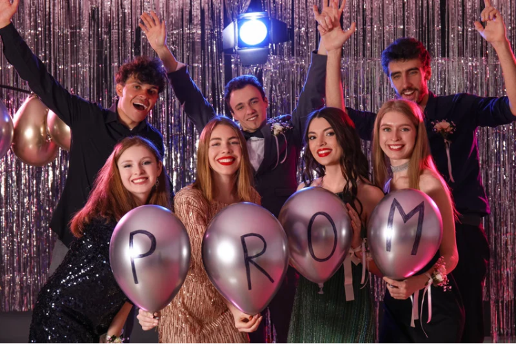 A group of friends smiling for the camera at a prom night