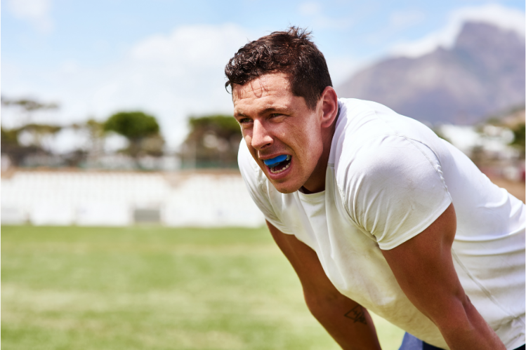 Athlete wearing a blue sports mouth guard on the field