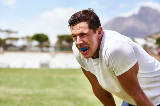Athlete wearing a blue sports mouth guard on the field