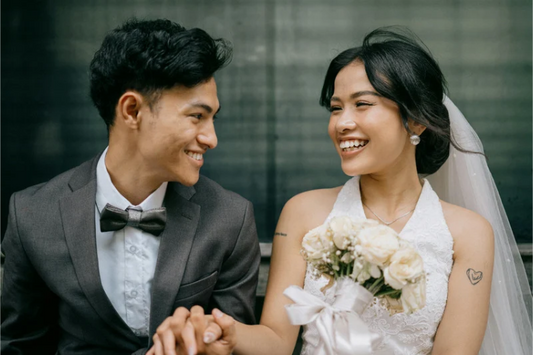 Smiling bride and groom holding hands on their wedding day