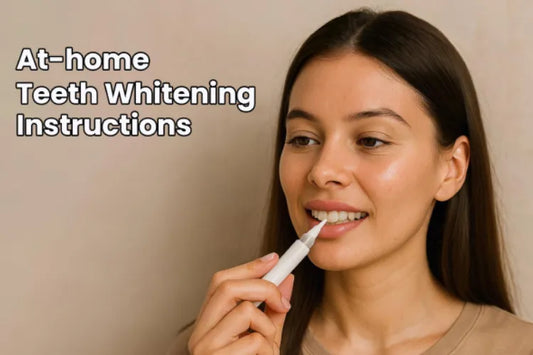  A girl holding a teeth whitening pen on her teeth
