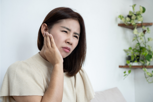 A woman experiencing stress-induced jaw pain