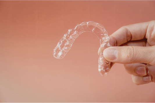 Clear braces on a grey background.