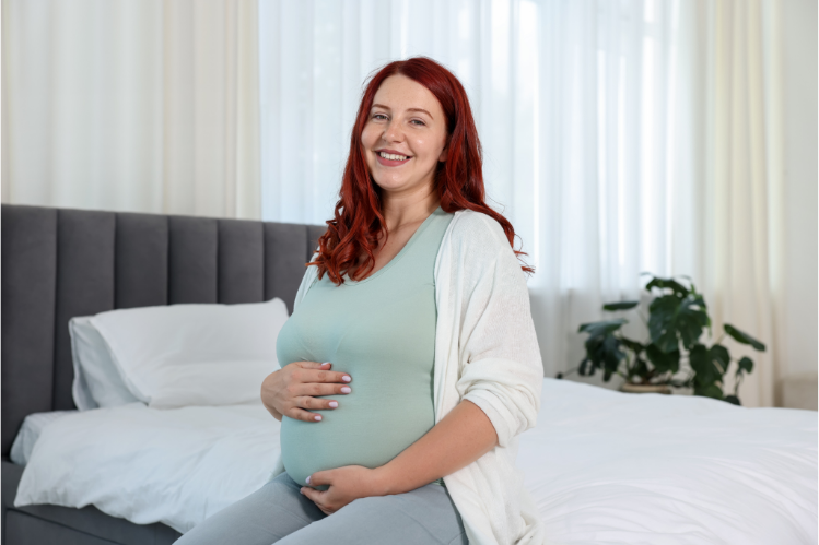  A pregnant woman smiling after finishing her clear aligner treatment mid-pregnancy