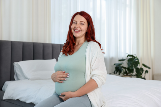 A pregnant woman smiling after finishing her clear aligner treatment mid-pregnancy