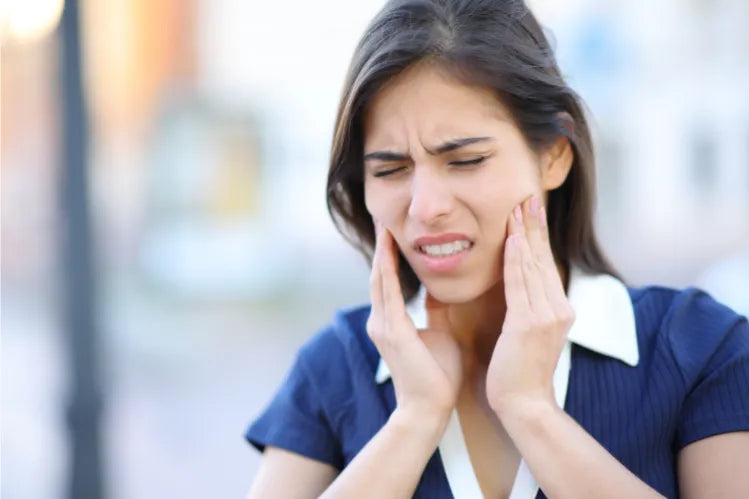 A woman suffering from TMJ