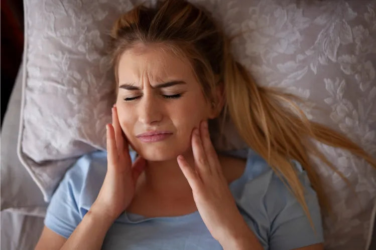 A woman sleeping with aligner pain