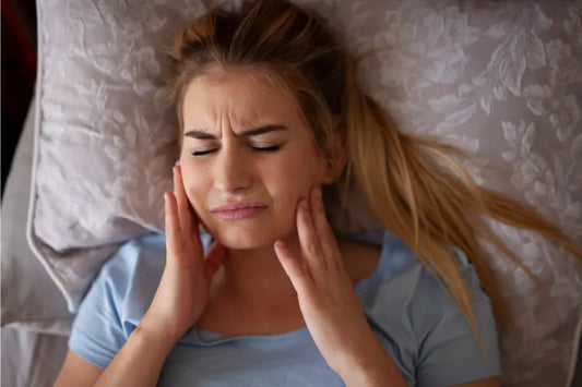 A woman sleeping with aligner pain
