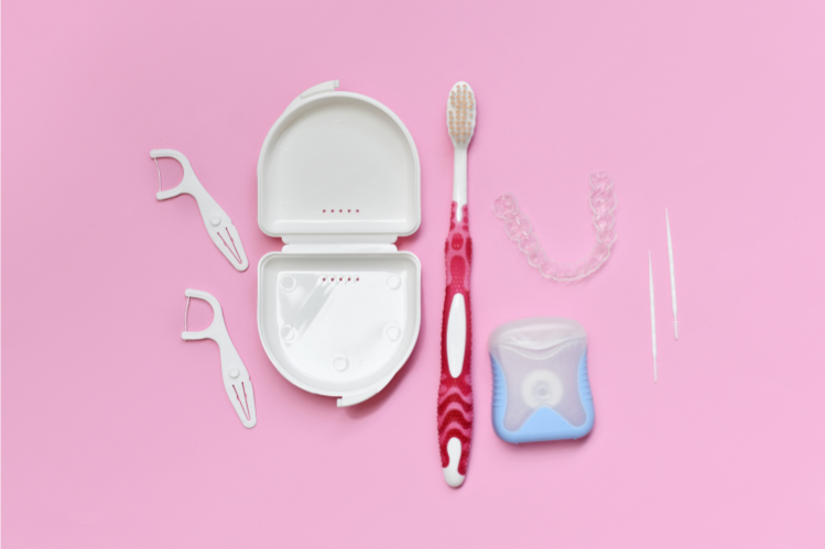 Clear aligners in a case with floss and a toothbrush.