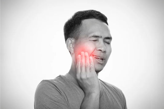  Man with jaw pain from grinding teeth at night.