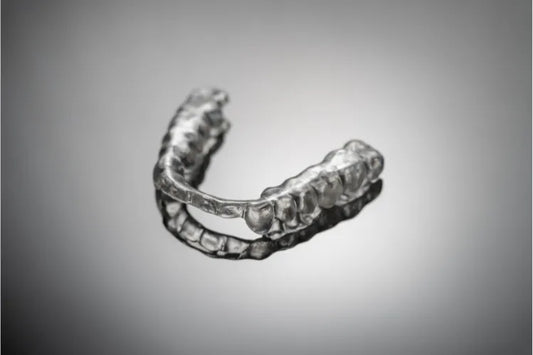  A dental night guard with a grey background.