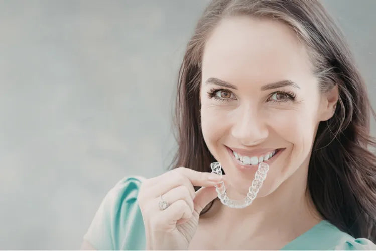  A girl applying clear aligners for facial symmetry 