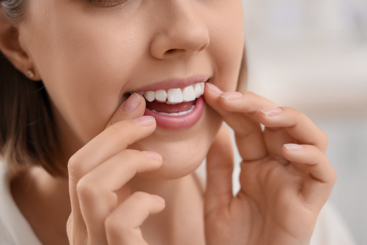A girl applying a dental night guard to prevent bruxism.