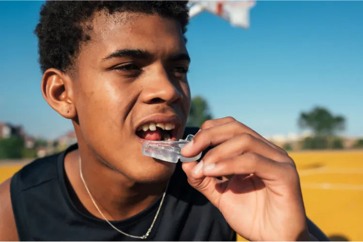 A kid wearing a mouthguard for teeth protection.