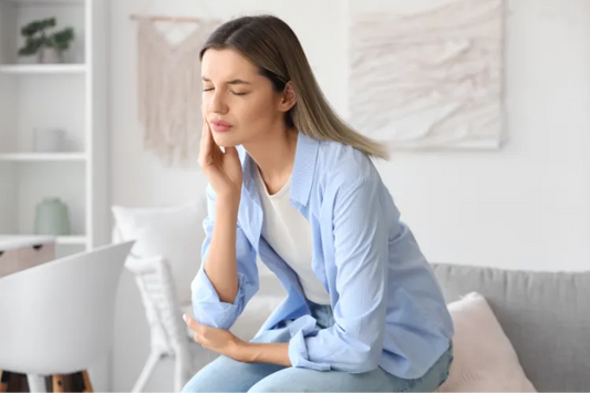 A woman experiencing tooth squeeze
