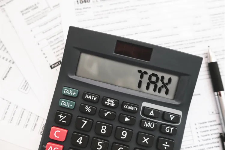  Tax documents and a calculator for claiming clear aligner treatment on the tax return.