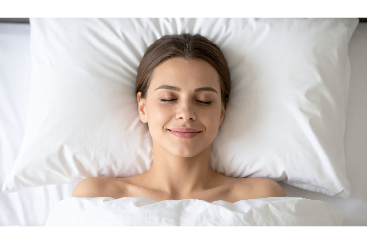 A girl sleeping in bed with night aligners, smiling.