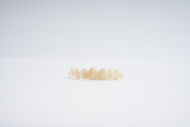 Dental Veneers placed on a plain surface.