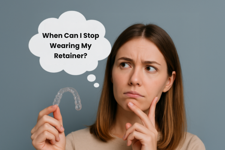 A girl holding a clear retainer, wondering if she can stop wearing retainers