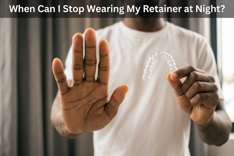 Man holding up a clear retainer with his other hand raised to stop