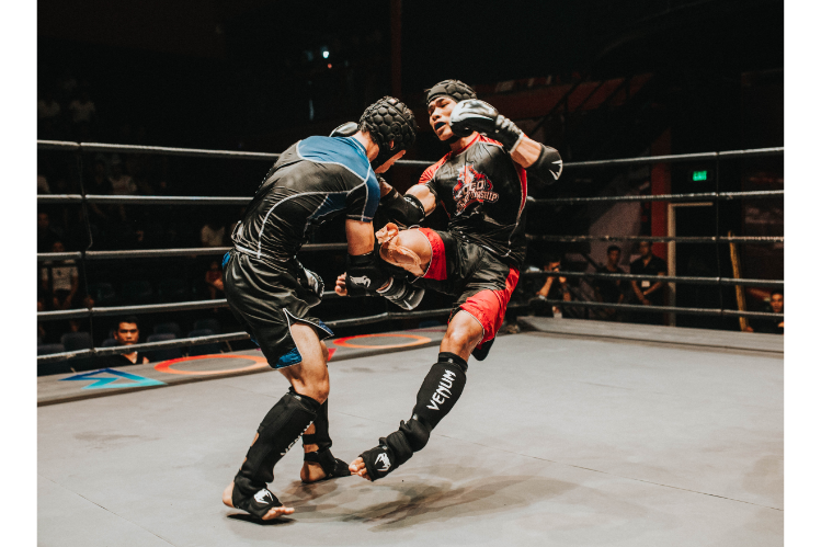Two kickboxers fighting in a ring during a match