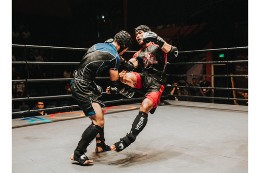 Two kickboxers fighting in a ring during a match