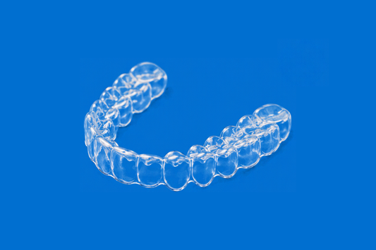 Clear night guard on a blue background for better sleep